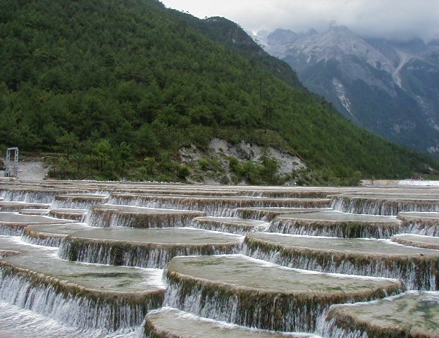 The snow is melting and the water flows down the mountain paths to create this little pond. The water is crystal clear and clean.